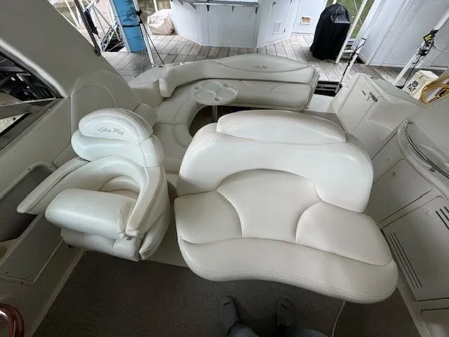 Slide: The Image of 1999 Sea Ray 38' Sundancer interior with white leather seating and helm area. - 11