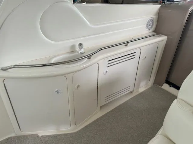 Slide: The Image of 1999 Sea Ray 38' Sundancer interior with sink and storage cabinets. - 19