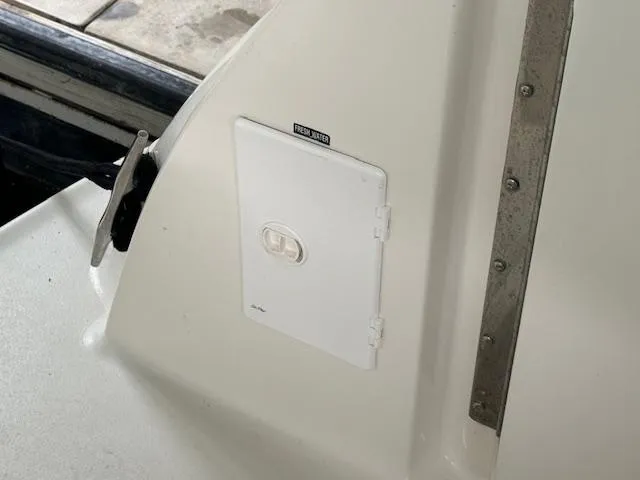 Slide: The Image of 1999 Sea Ray 38' Sundancer boat detail showing a fresh water access panel. - 22