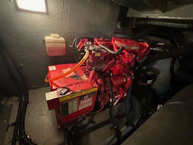 Slide: The Image of Engine room of a 1999 Sea Ray 38' Sundancer with visible red machinery. - 24