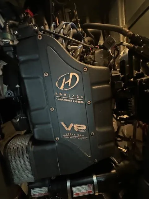 Slide: The Image of Engine compartment of a 1999 Sea Ray 38' Sundancer, featuring a MerCruiser Horizon V8 engine. - 26