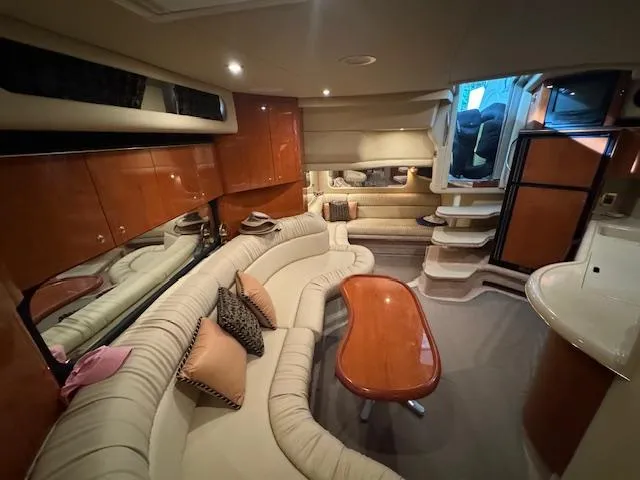 Slide: The Image of Luxurious interior of a 1999 Sea Ray 38' Sundancer yacht with elegant seating and wood finishes. - 29
