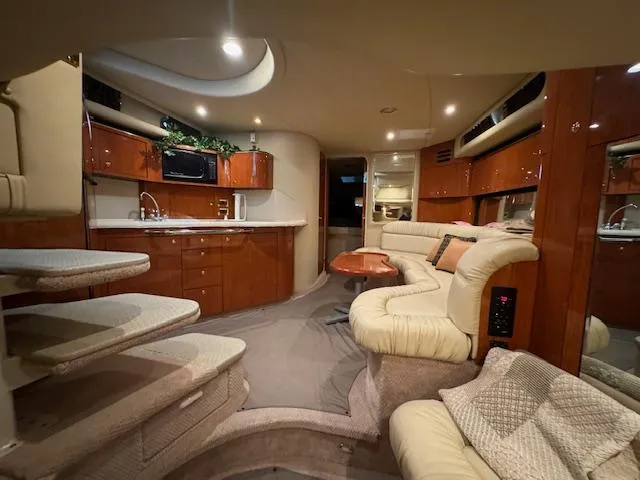 Slide: The Image of Luxurious interior of a 1999 Sea Ray 38' Sundancer yacht with plush seating and kitchenette. - 30