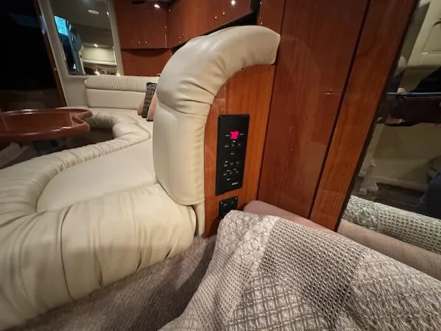 Slide: The Image of Luxurious interior of 1999 Sea Ray 38' Sundancer yacht with plush seating and control panel. - 31