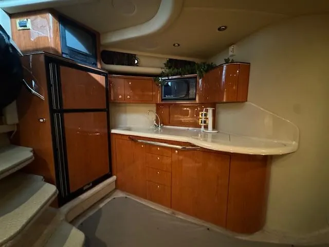 Slide: The Image of Interior of a 1999 Sea Ray 38' Sundancer yacht with a modern kitchen area. - 34