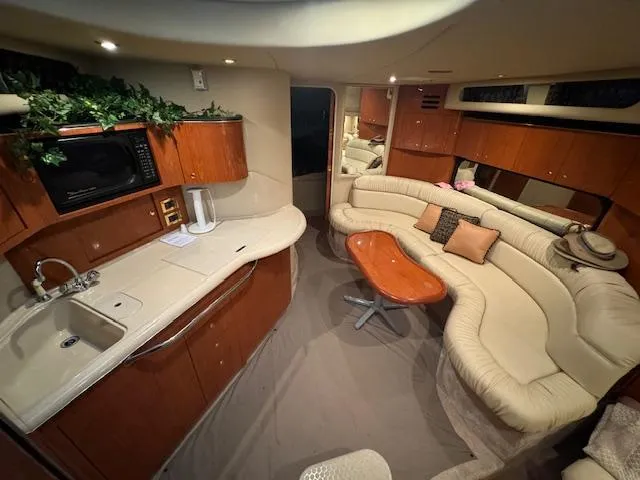 Slide: The Image of Luxurious interior of a 1999 Sea Ray 38' Sundancer yacht with elegant seating and kitchenette. - 37