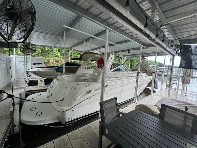 Slide: The Image of 1999 Sea Ray 38' Sundancer docked under a covered marina with outdoor seating. - 4