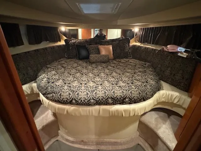 Slide: The Image of Luxurious cabin interior of 1999 Sea Ray 38' Sundancer with elegant bedding and ambient lighting. - 41
