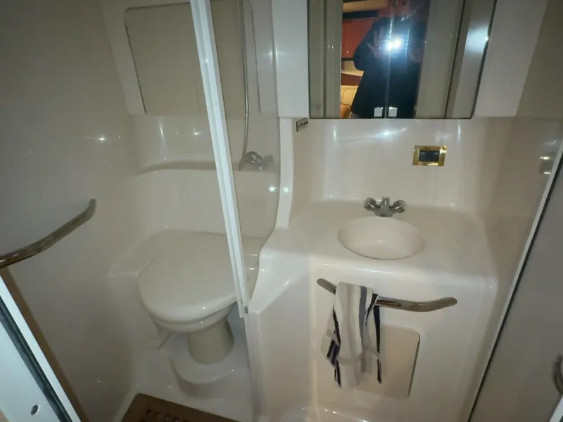 Slide: The Image of Bathroom interior of 1999 Sea Ray 38' Sundancer yacht, featuring sink and toilet. - 44