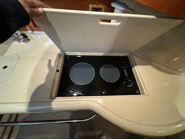 Slide: The Image of 1999 Sea Ray 38' Sundancer kitchen with a two-burner electric stove. - 47