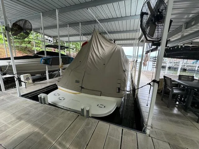 Slide: The Image of 1999 Sea Ray 38' Sundancer covered in a dock with fans and seating area. - 49