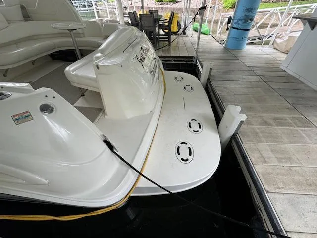 Slide: The Image of 1999 Sea Ray 38' Sundancer docked, showing rear deck and seating area. - 8