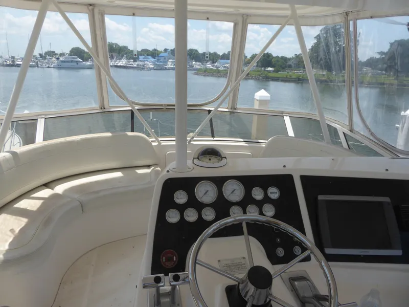 Slide: The Image of Helm of 2000 Silverton 42C yacht with Cummins 450 Diesels, overlooking marina. - 10