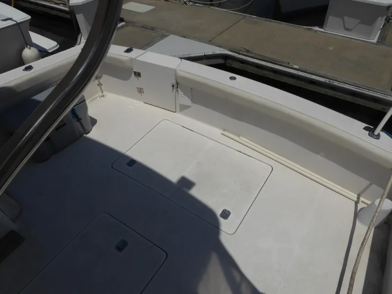 Slide: The Image of 2000 Silverton 42C Cummins boat deck with storage compartments and railing. - 12