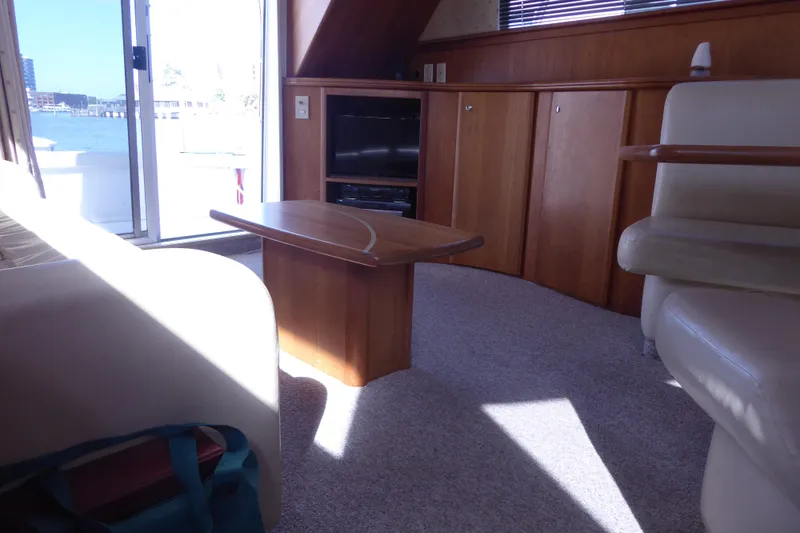 Slide: The Image of Interior of 2000 Silverton 42C yacht with wooden cabinetry and seating area. - 22