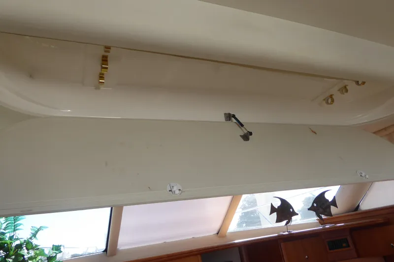 Slide: The Image of Open storage compartment in 2000 Silverton 42C Cummins yacht interior, featuring decorative fish accents. - 24