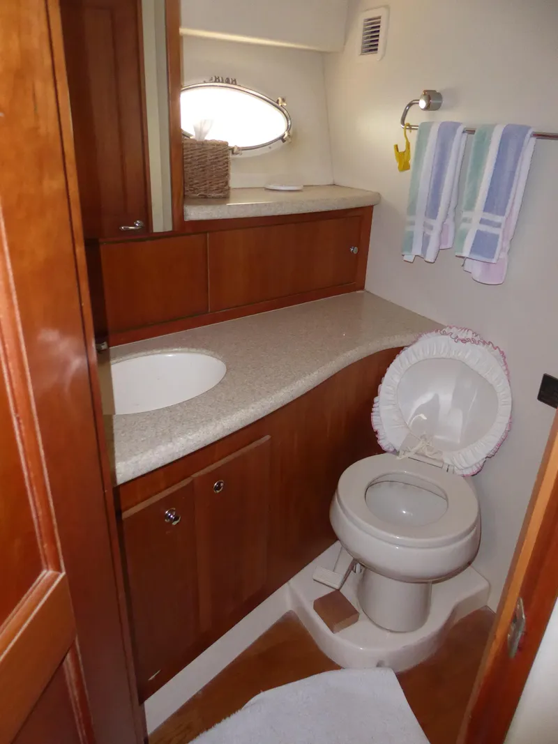 Slide: The Image of Luxurious bathroom in 2000 Silverton 42C yacht with wooden cabinetry and modern fixtures. - 31