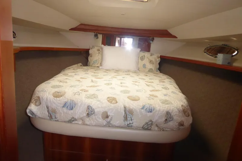 Slide: The Image of Cozy bedroom in 2000 Silverton 42C Cummins yacht with seashell-themed bedding. - 34