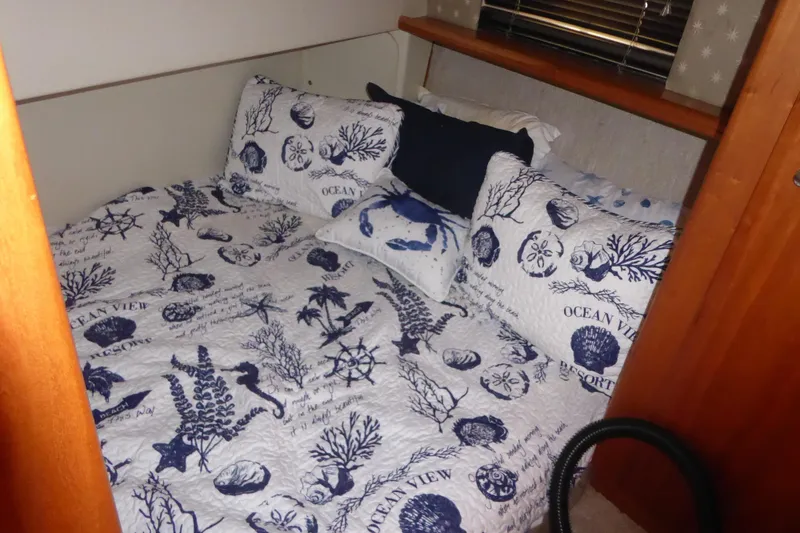 Slide: The Image of Cozy nautical-themed bedroom in a 2000 Silverton 42C Cummins yacht. - 37