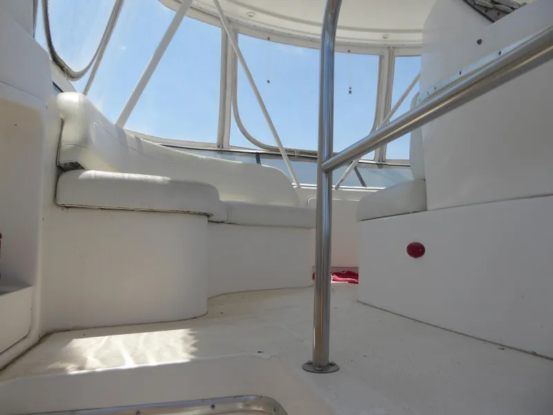 Slide: The Image of Interior view of 2000 Silverton 42C yacht with white seating and metal railings. - 5