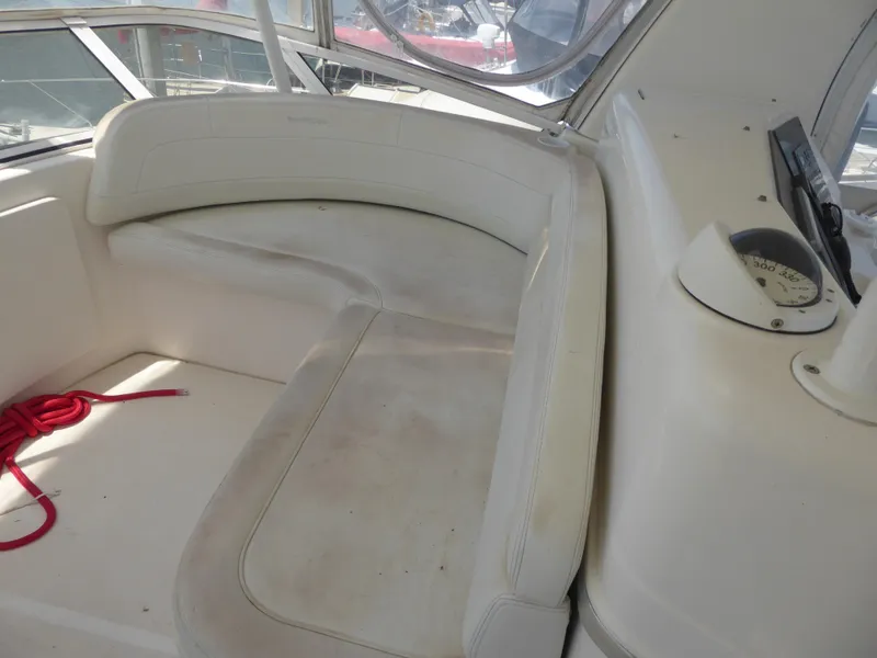 Slide: The Image of Interior of 2000 Silverton 42C boat with white seating and navigation instruments. - 6