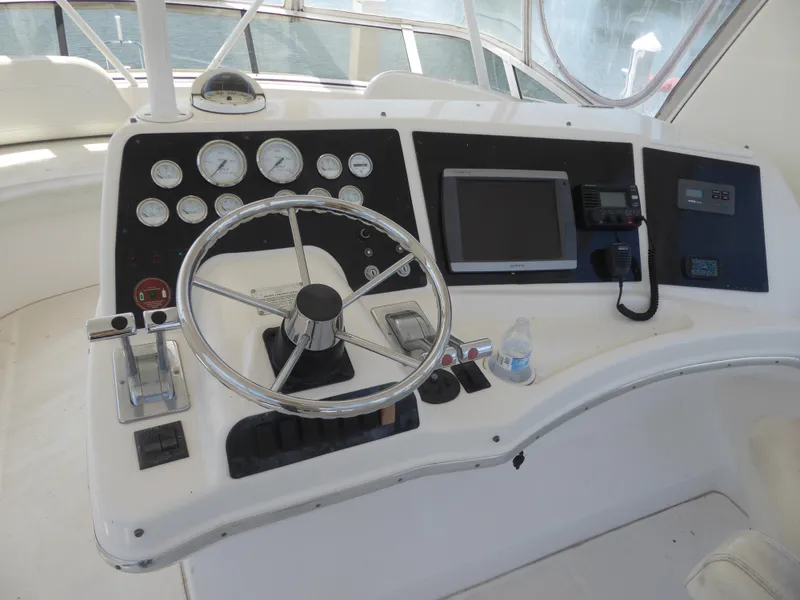 Slide: The Image of Helm of 2000 Silverton 42C Cummins 450 Diesels with steering wheel and gauges. - 9