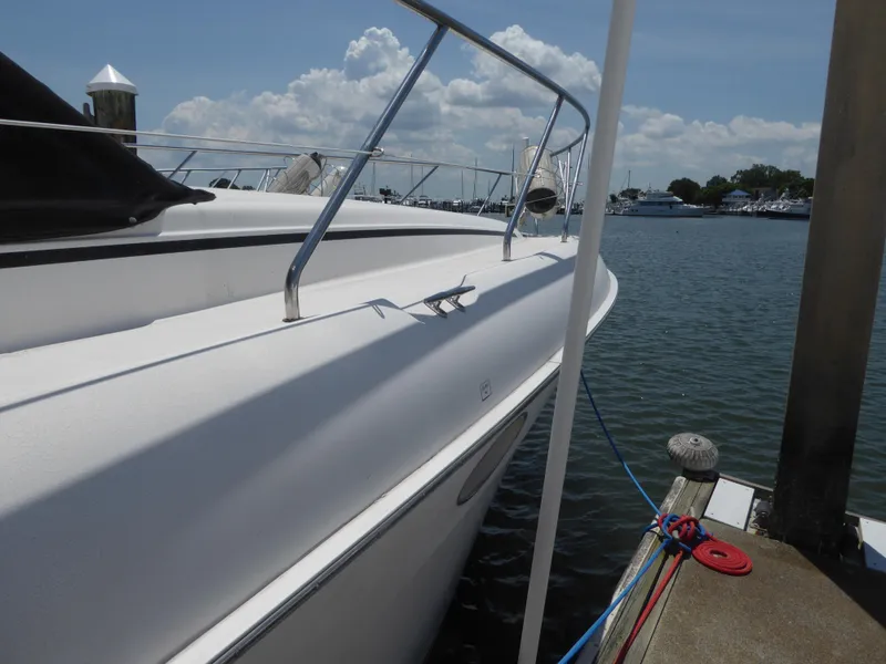 Slide: The Image of 2000 Silverton 42C Cummins 450 Diesels yacht docked at marina. - 13