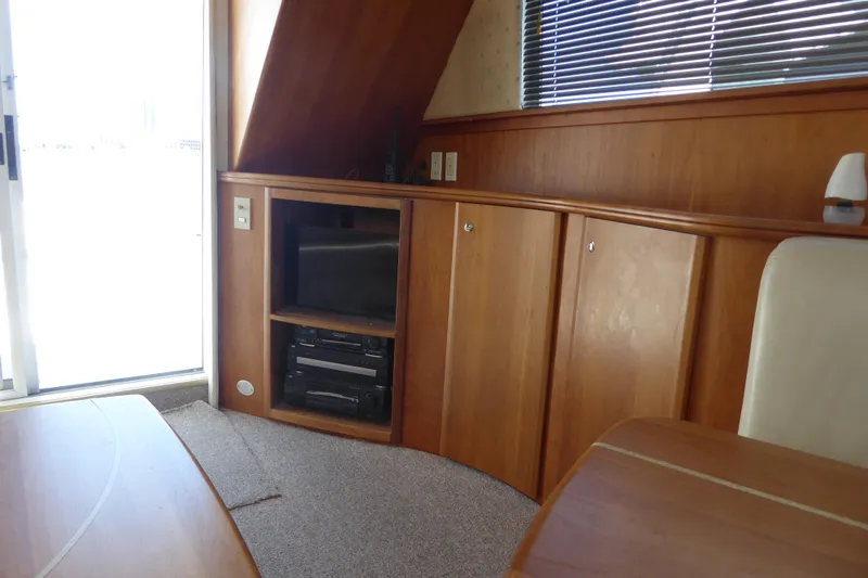 Slide: The Image of Interior of 2000 Silverton 42C yacht with wood cabinetry and entertainment center. - 17