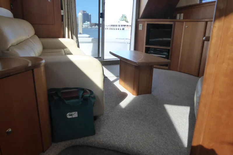 Slide: The Image of Interior of 2000 Silverton 42C yacht with beige seating and wooden cabinetry. - 23