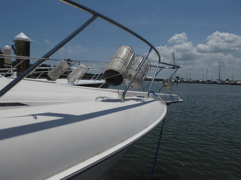 Slide: The Image of 2000 Silverton 42C Cummins yacht docked at marina under clear blue sky. - 3