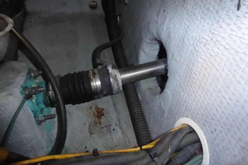 Slide: The Image of Engine compartment of 2000 Silverton 42C Cummins 450 Diesels, showing shaft and hoses. - 40