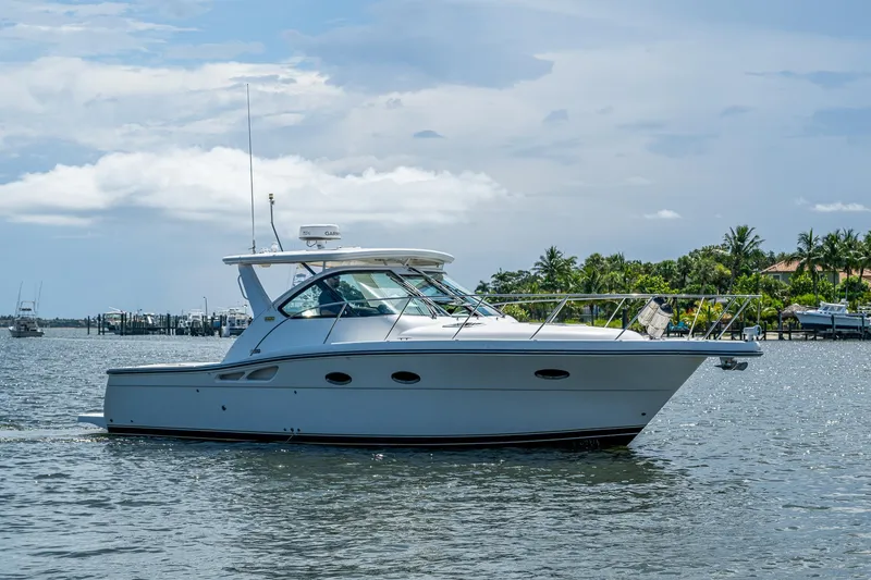 Slide: The Image of 2008 Tiara Yachts 3200 Open cruising on a sunny day near a tropical shoreline. - 1