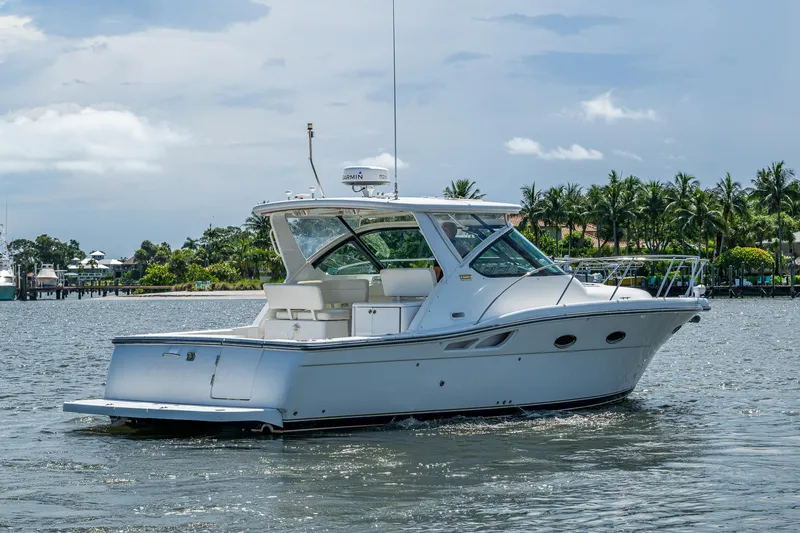 Slide: The Image of 2008 Tiara Yachts 3200 Open cruising on a scenic waterway with palm trees. - 10