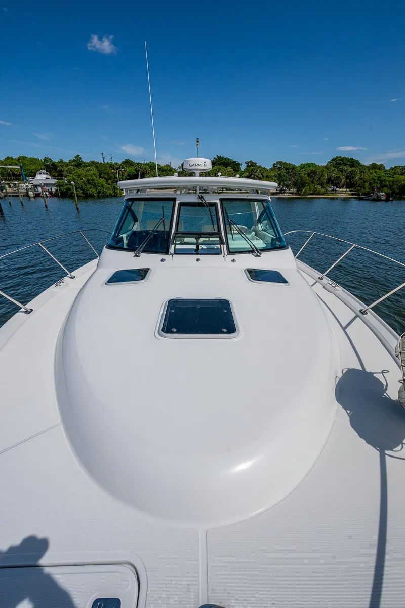 Slide: The Image of 2008 Tiara Yachts 3200 Open on water, showcasing sleek deck and cabin design. - 13