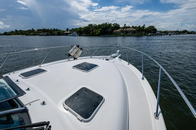 Slide: The Image of 2008 Tiara Yachts 3200 Open cruising on a scenic waterway under a partly cloudy sky. - 15