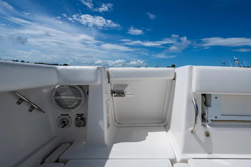 Slide: The Image of 2008 Tiara Yachts 3200 Open deck with white seating and blue sky background. - 19
