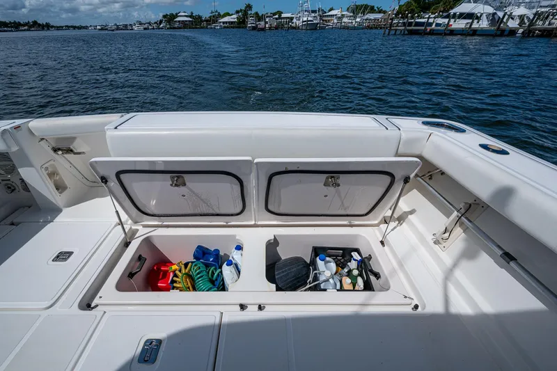 Slide: The Image of 2008 Tiara Yachts 3200 Open with open storage compartments, docked by the water. - 20