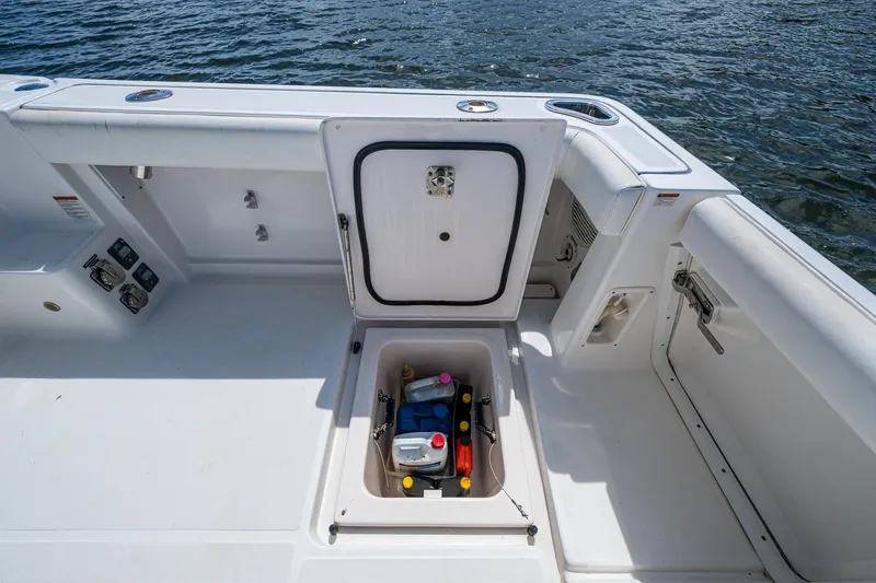 Slide: The Image of 2008 Tiara Yachts 3200 Open deck with storage compartment open, showing supplies. - 21