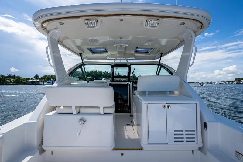 Slide: The Image of 2008 Tiara Yachts 3200 Open boat interior with seating and storage, on a sunny day. - 23