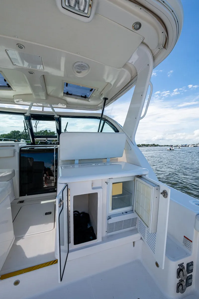 Slide: The Image of 2008 Tiara Yachts 3200 Open interior with open storage, overlooking a scenic water view. - 24