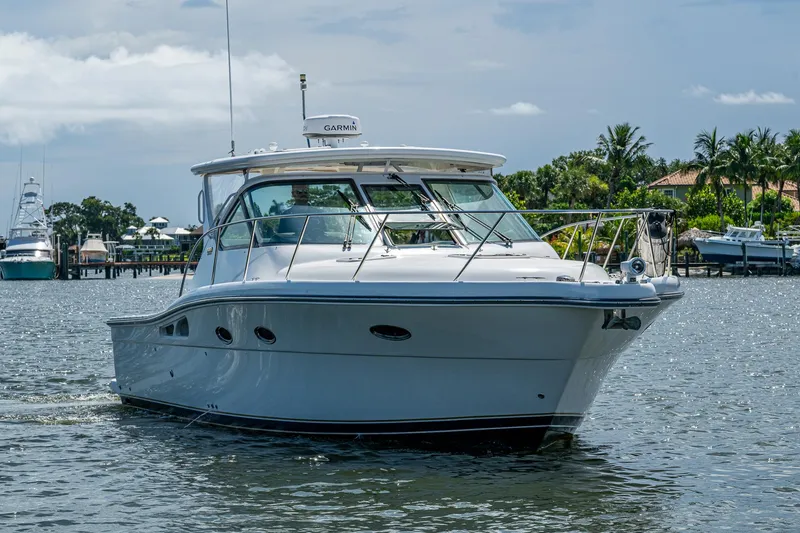 Slide: The Image of 2008 Tiara Yachts 3200 Open cruising on a sunny day near a marina. - 3