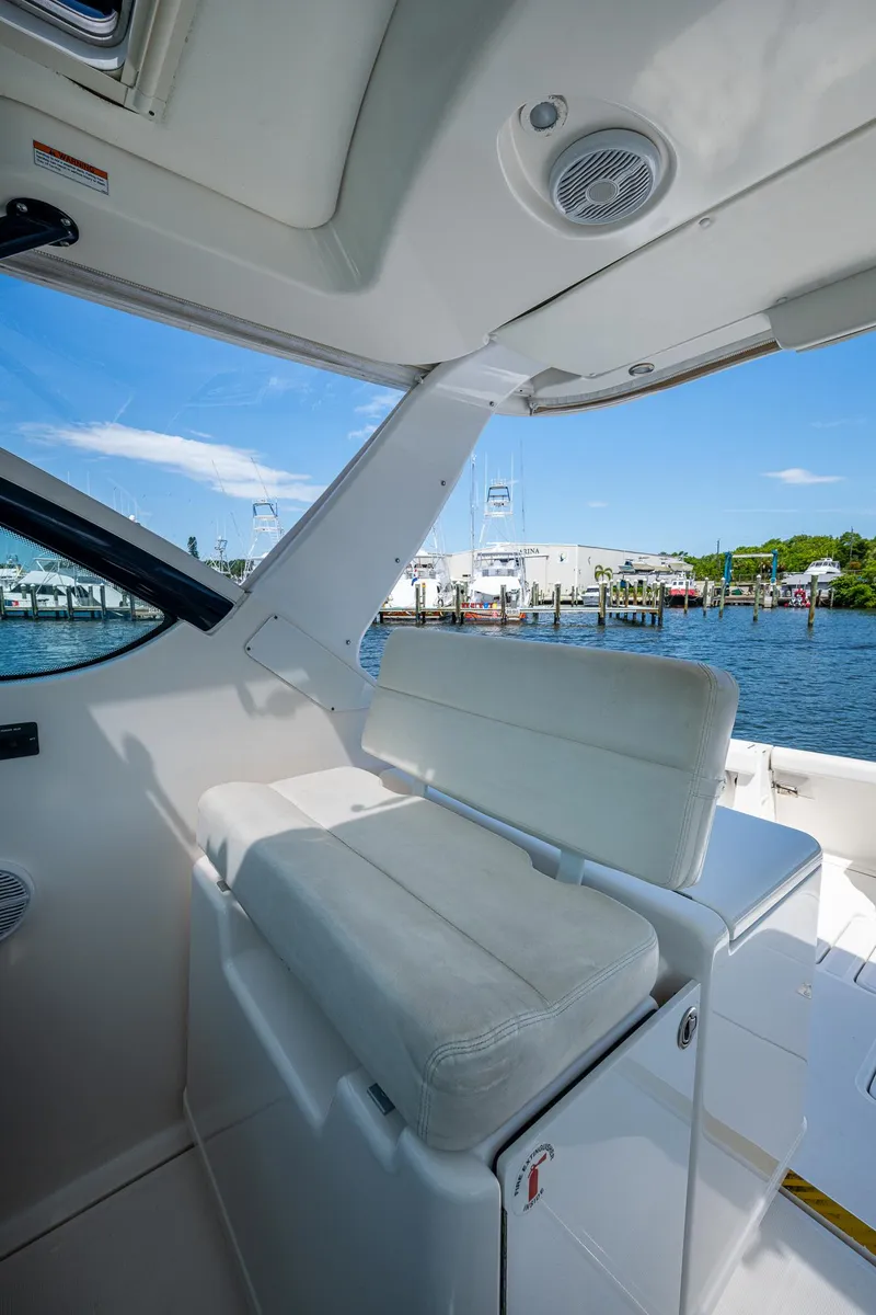 Slide: The Image of 2008 Tiara Yachts 3200 Open interior with white seating, dockside view. - 30