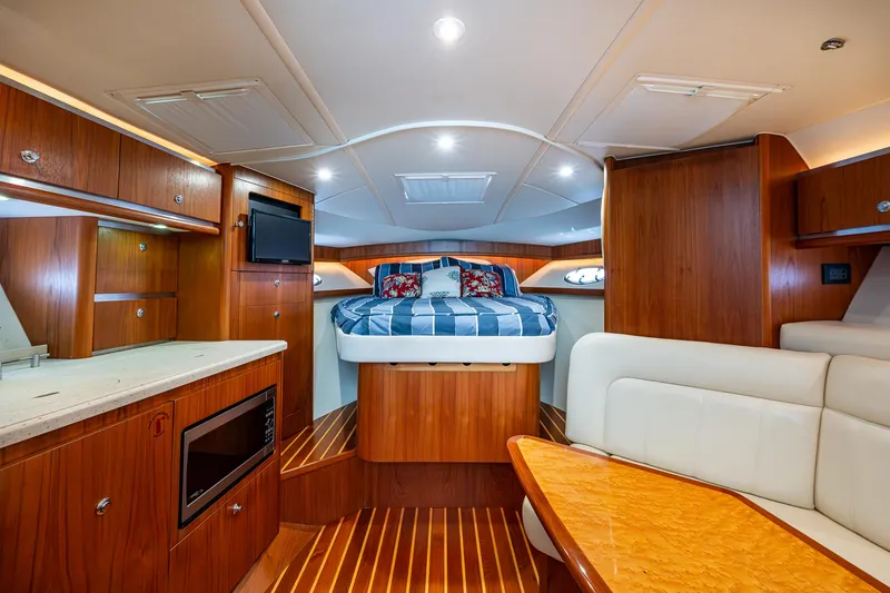 Slide: The Image of Luxurious interior of 2008 Tiara Yachts 3200 Open with wood finish and cozy bed. - 33