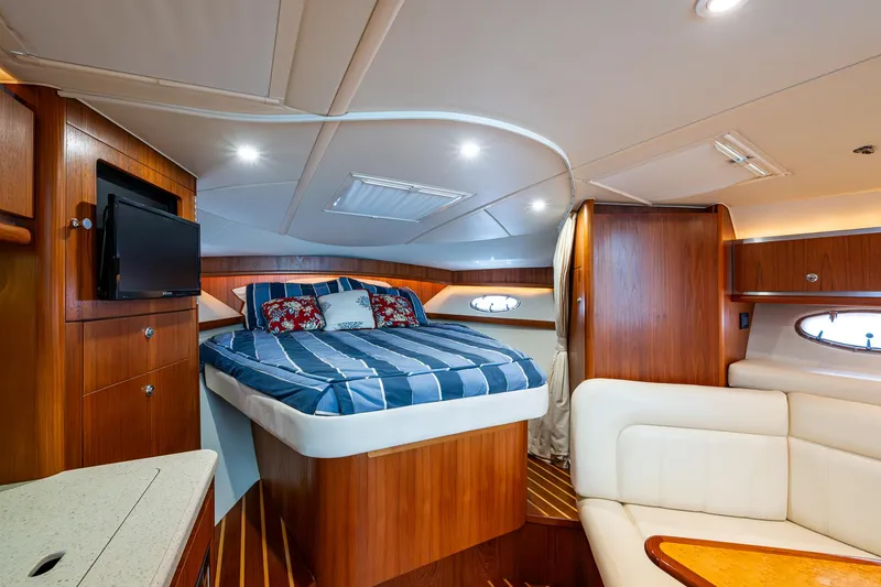 Slide: The Image of Luxurious 2008 Tiara Yachts 3200 Open cabin interior with bed, TV, and seating area. - 34