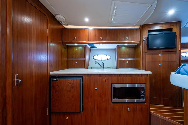 Slide: The Image of Luxurious 2008 Tiara Yachts 3200 Open interior with wood cabinetry and modern amenities. - 36