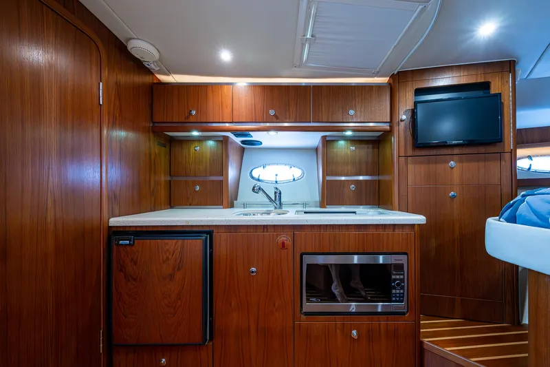 Slide: The Image of Luxurious 2008 Tiara Yachts 3200 Open interior with wood cabinetry and modern amenities. - 38