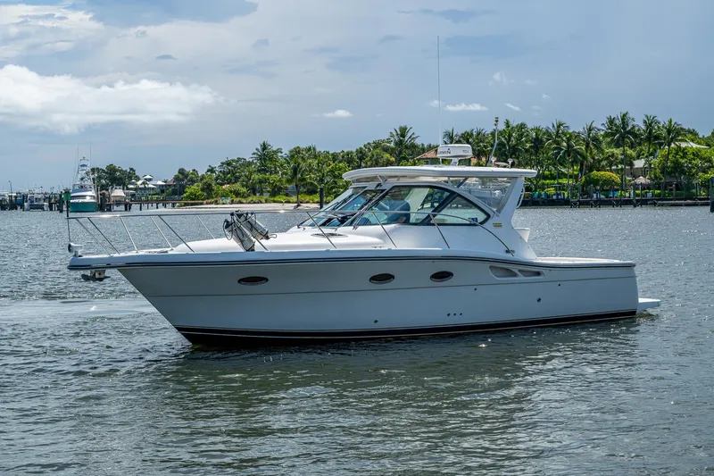 Slide: The Image of 2008 Tiara Yachts 3200 Open cruising on a scenic waterway with lush greenery. - 5
