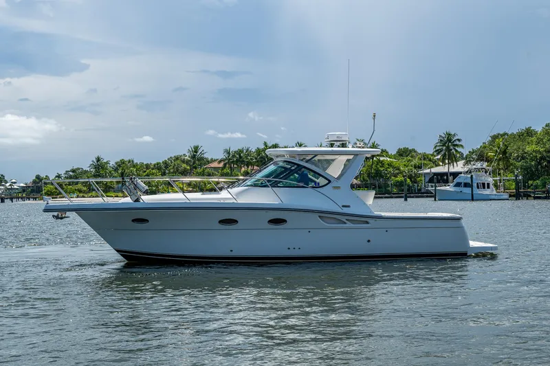 Slide: The Image of 2008 Tiara Yachts 3200 Open cruising on a calm waterway with lush greenery. - 6