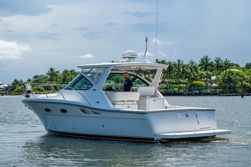 Slide: The Image of 2008 Tiara Yachts 3200 Open cruising on a sunny day with palm trees in the background. - 7