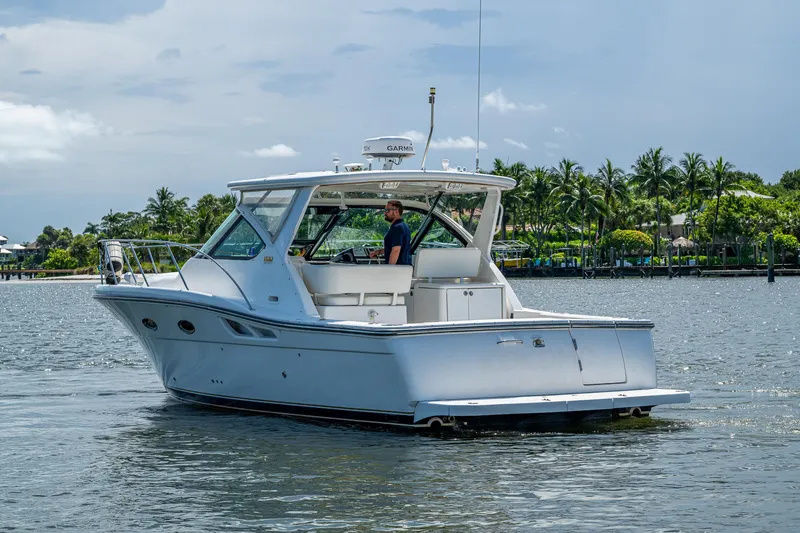 Slide: The Image of 2008 Tiara Yachts 3200 Open cruising on a sunny day near palm-lined shore. - 8